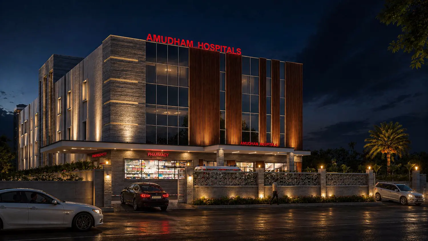 Amudham Hospitals, the lit entrance elevation at night.